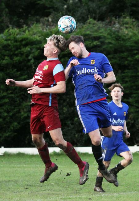 Morgan Broomhall of Saundersfoot and Shaun Whitfield of Carew in a mid air challenge for the ball. Picture Susan McKehon